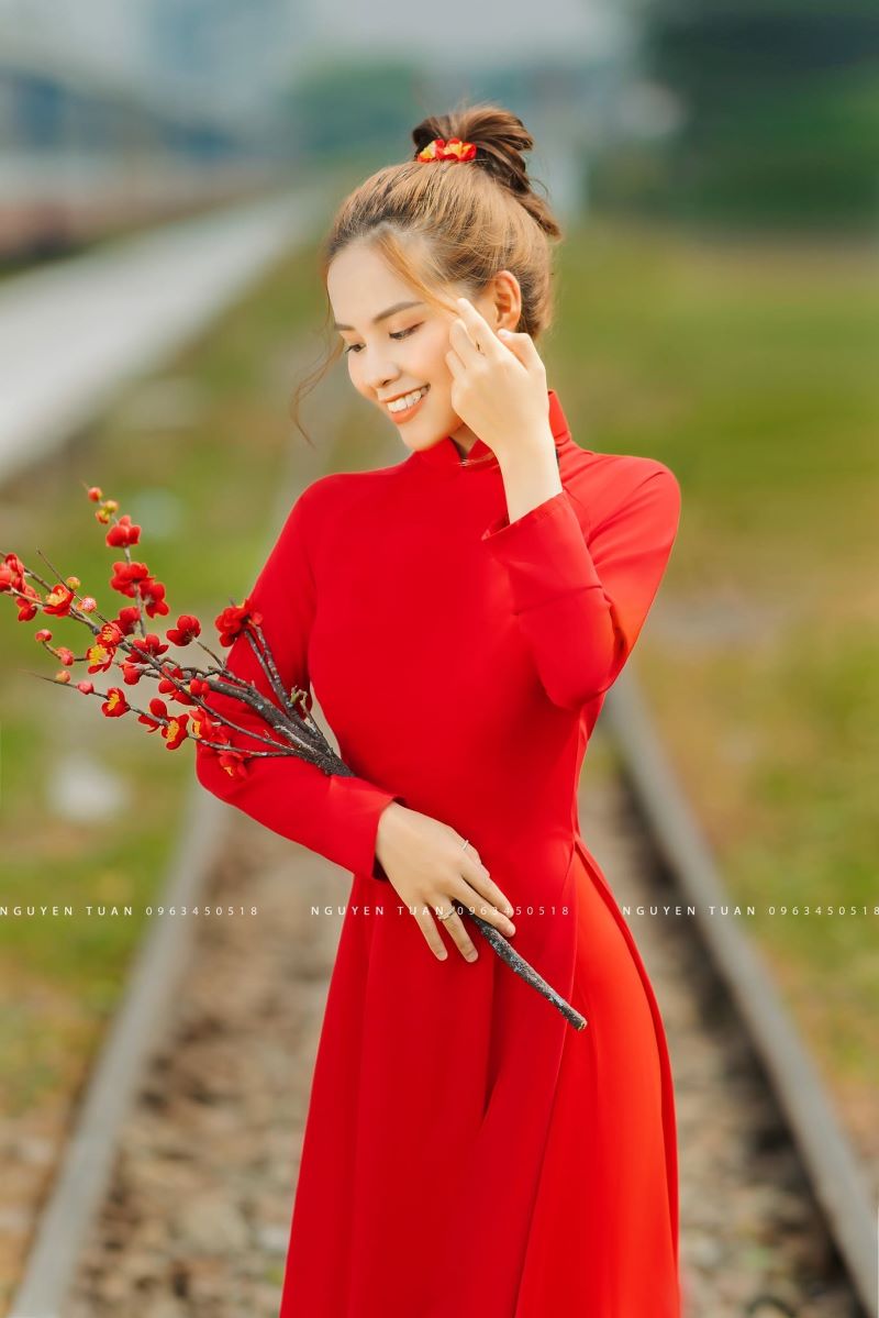 Chụp hình tết với áo dài cách tân đỏ cầm hoa xinh đẹp